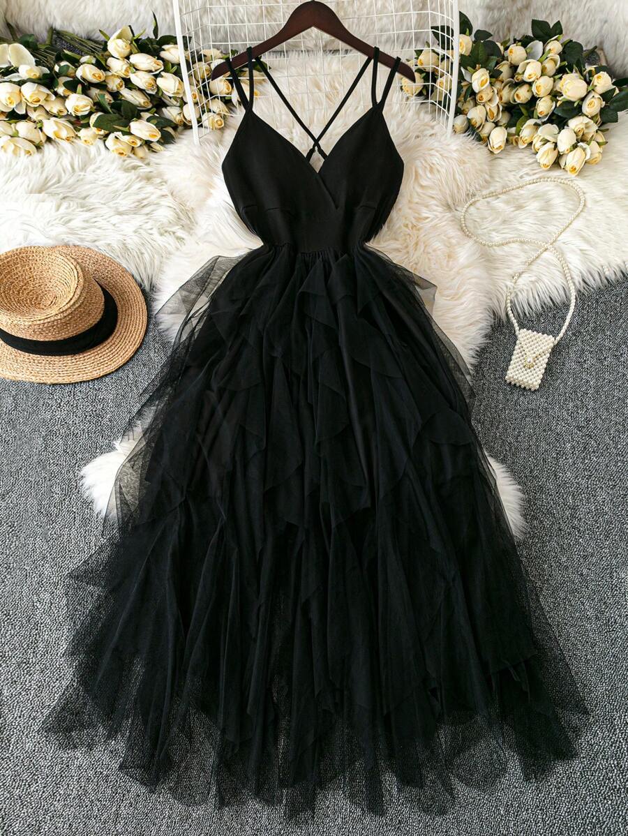 This plus size dusty blue cami dress brings playful elegance with its crisscross straps and tiered tulle skirt. Perfect for romantic summer dates, it flatters your silhouette while adding flirty movement to every step. Embrace effortless charm and stay cool in this dreamy, whimsical dress made for making memories.
