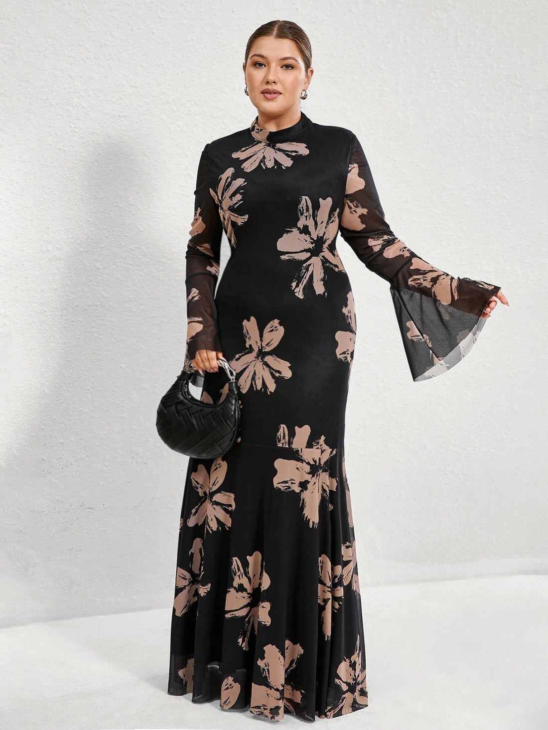 Get ready to turn heads in this elegant French-style plus size bodycon dress! Featuring a gorgeous floral print with a chic black background and flared sleeves, this dress is perfect for any occasion. Show off your curves and your unique sense of style in this statement-making piece. (Plus, it's just as comfortable as it is stunning!)