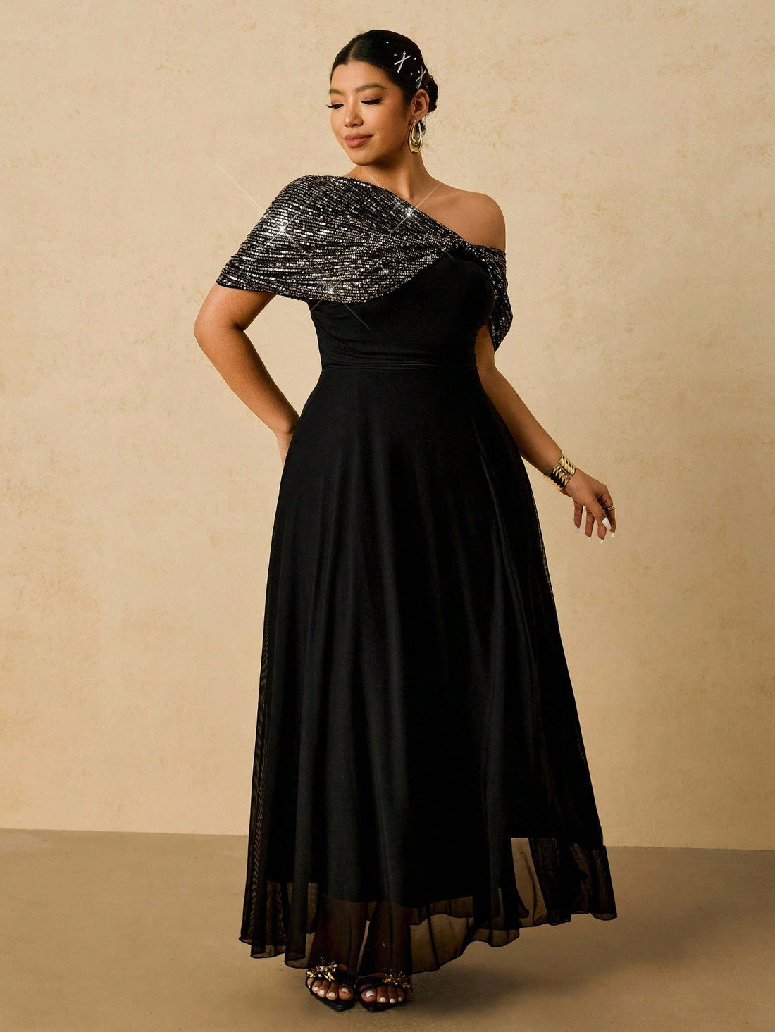 Shine bright like the star you are in this stunning plus-size sequin dress! Featuring an eye-catching asymmetrical hemline and shimmering sequin details, this elegant gown is your ticket to turning heads at any celebration. The flowing silhouette flatters beautifully while the luxe fabric catches the light with every move. Perfect for holiday parties, special events, or whenever you want to feel absolutely fabulous. Dress it up with heels and statement jewelry for maximum glamour!