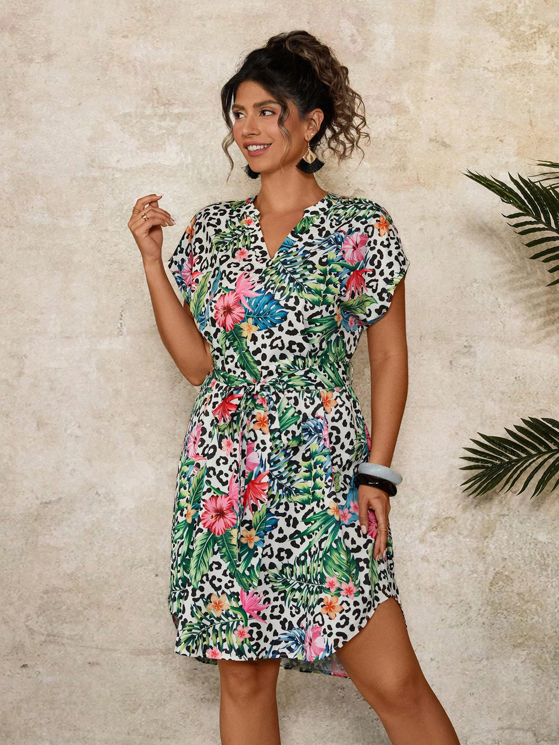 Step into summer in style with this playful plus size leopard tropical floral print dress. Its breezy, short sleeves and wrap design offer comfort and a flattering fit, perfect for casual outings or holiday fun. Embrace bold patterns that brighten your day and turn heads wherever you go.