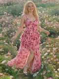 Model wearing pink floral ruffle maxi dress in a flower field