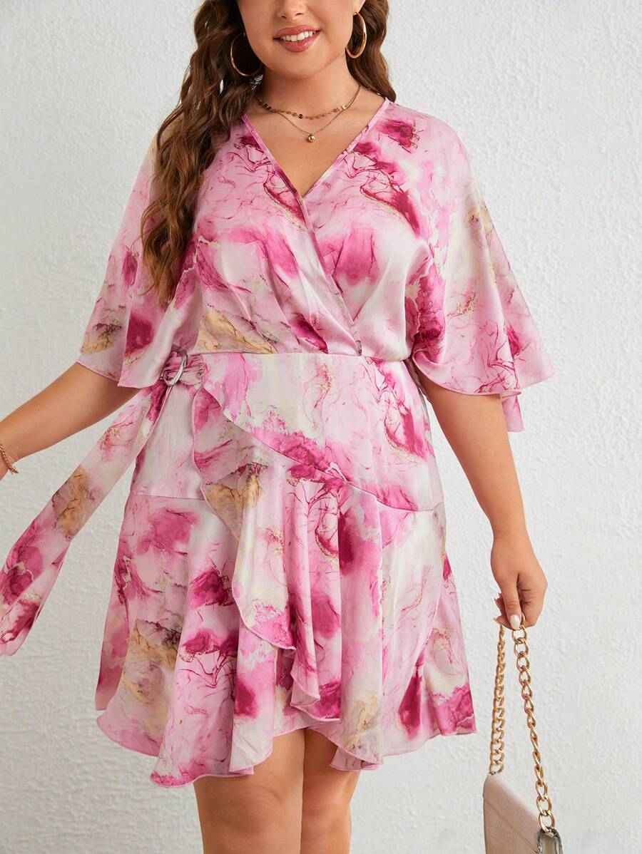 Elevate your wardrobe with this stunning marble print wrap dress that's as fun as it is flattering. The playful ruffle trim adds a touch of whimsy, while the signature side knot creates an instantly polished silhouette that works for any occasion. Designed with plus-size curves in mind, this dress offers comfort without compromising on style. Slip it on and let the effortless elegance do the talking—because looking fabulous should feel like second nature.