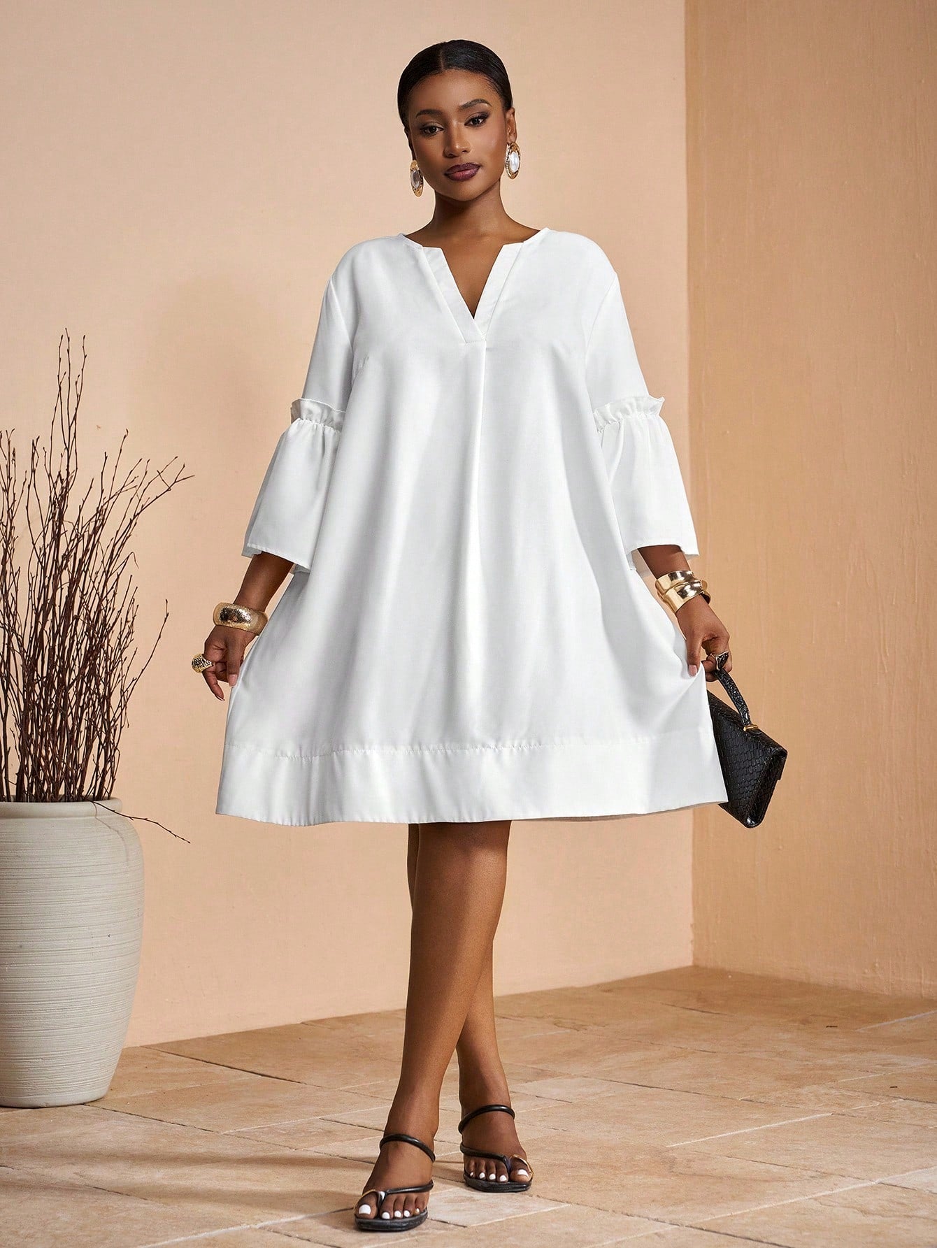 Step into sunshine with this playful plus size mini shirt dress! Featuring a breezy white fabric, a flattering V-neck, and comfy raglan sleeves, it's perfect for spring and summer fun. Whether you're strolling on vacation or sipping lemonade in the backyard, this dress keeps you cool and casual with effortless style.