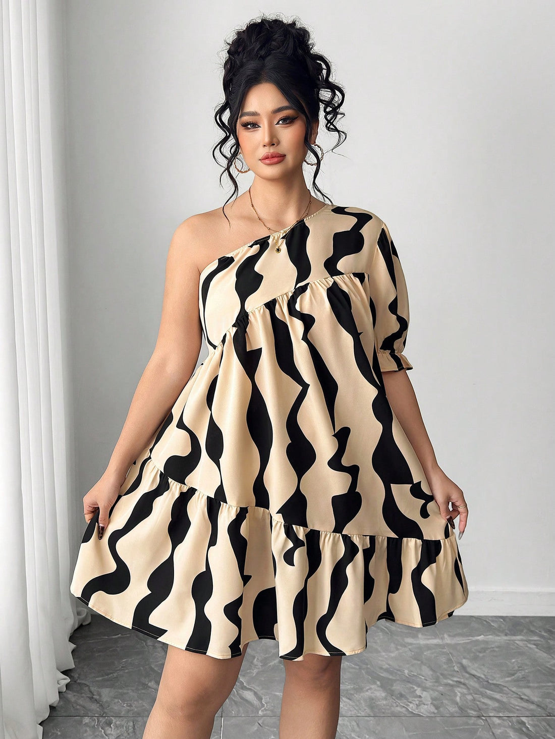 Embrace your curves with this show-stopping plus-size dress that proves minimalism can be bold. Layered geometric prints create visual intrigue while asymmetric lantern sleeves add a playful twist that catches every eye. The thoughtful construction flatters your silhouette, offering comfort without compromise. Perfect for turning heads at brunch, date night, or whenever you want to feel effortlessly chic. This dress celebrates your style with personality and flair.