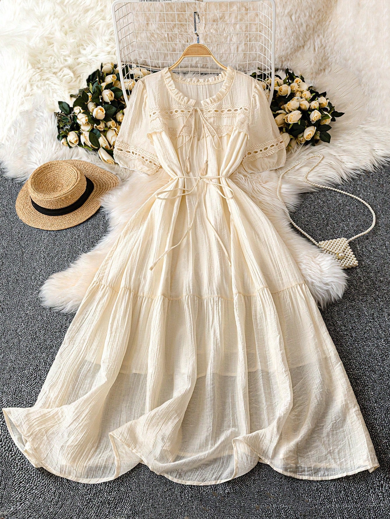 Embrace your romantic side in this plus size pale peach dress, featuring a playful textured fabric and a flirty ruffle hem. The flounce neckline adds a touch of whimsy, while the tassel waist tie lets you cinch in your silhouette for a flattering fit. Perfect for dreamy dates or special outings, this dress combines comfort and charm effortlessly.