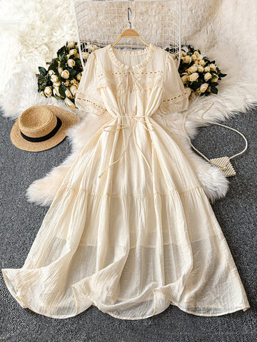 Embrace your romantic side in this plus size pale peach dress, featuring a playful textured fabric and a flirty ruffle hem. The flounce neckline adds a touch of whimsy, while the tassel waist tie lets you cinch in your silhouette for a flattering fit. Perfect for dreamy dates or special outings, this dress combines comfort and charm effortlessly.