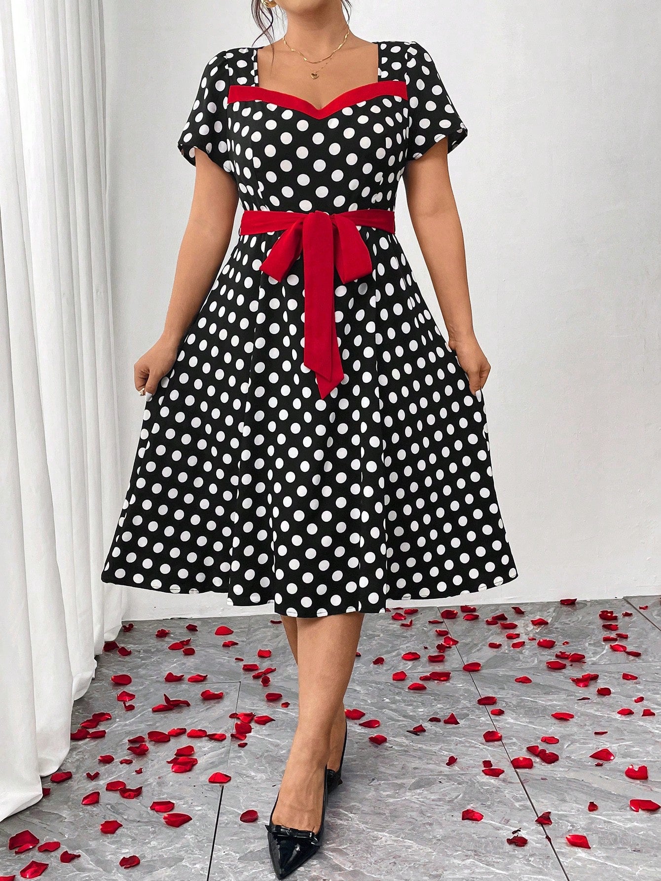 Step into the spotlight in this charming plus-size polka dot dress that blends vintage allure with modern elegance. The cinched waist creates a flattering silhouette that celebrates your curves, while classic polka dots add a playful, timeless touch. Perfect for parties, date nights, or any occasion calling for a dash of retro-inspired style. This dress proves that fashion-forward doesn't mean compromising on comfort or confidence. Twirl, dance, and shine in a piece designed to make you feel absolutely fabu