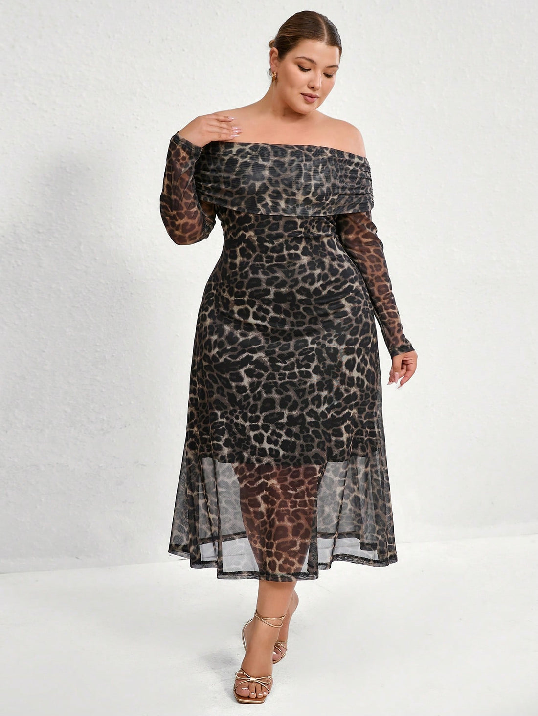 Turn heads effortlessly in this plus size leopard print maxi dress. The off-shoulder neckline adds a flirty touch, while the long sleeves balance the look with elegance. A cinched waist flatters your curves, creating a confident silhouette. Perfect for making a bold statement with playful charm.