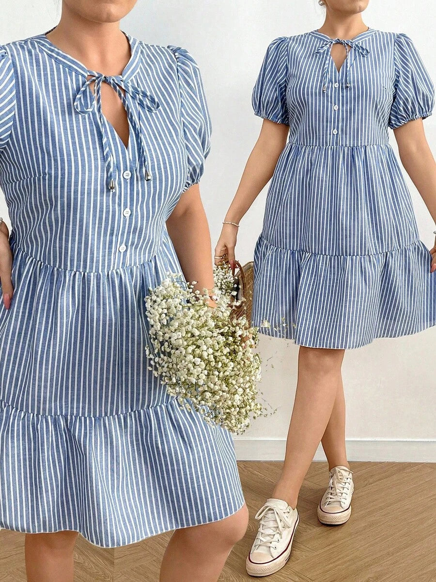 Stripes meet style in this playful plus-size mini dress that's ready to turn heads. The flattering V-neckline and adjustable drawstring create a customizable fit, while the trendy patchwork design adds visual interest and personality. Short sleeves keep things breezy and comfortable, making it perfect for casual outings, weekend adventures, or whenever you want to feel confident and fabulous. Mix and match with your favorite sneakers or sandals for an effortless look that celebrates your unique style.