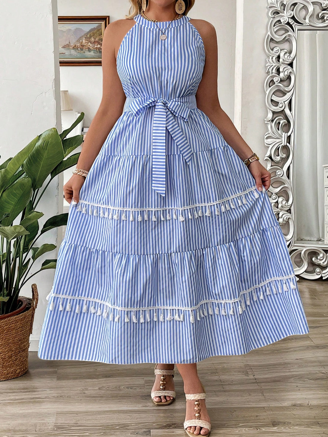 Embrace summer vibes with this playful plus size dress! Bold stripes meet whimsical floral fringed hem for a look that's both fun and flattering. The sleeveless design keeps you cool during warm-weather adventures, while the eye-catching details ensure you'll stand out at barbecues, beach trips, or casual get-togethers. Comfort meets style in this summer essential!