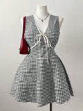 This playful plus size summer dress features a flattering V-neck and vibrant color block design that brightens your day. The charming bowtie adds a touch of whimsy, while the plaid hem brings a fun, unexpected twist. Perfect for sunny outings, it combines comfort and style effortlessly.
