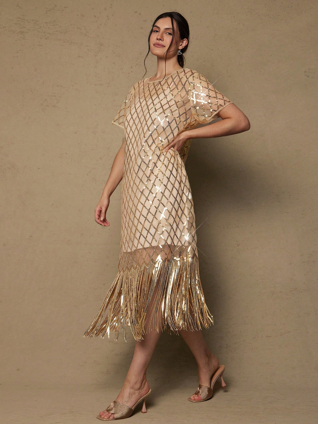Shimmer and shine in this show-stopping plus-size sequin dress, designed for those unforgettable moments. Vintage-inspired details meet modern glamour with cascading tassels that catch the light with every twirl. Perfect for holiday celebrations, romantic evenings, or any occasion calling for extra sparkle. The flattering cut celebrates your curves while the luxe sequin fabric ensures you'll be the most dazzling guest in the room. Dress it up with heels and statement jewelry for maximum impact.