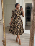 Front view of leopard print fit and flare midi dress with elbow sleeves