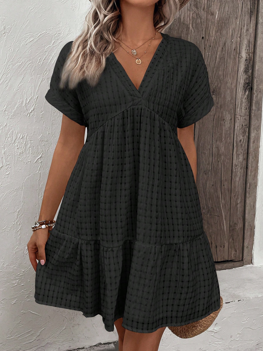 Flaunt your curves in this playful plus-size mini dress! The bubble plaid pattern adds a fun twist to your spring and summer wardrobe, while the flirty flare silhouette and flattering V-neckline create the perfect casual-chic look. Twirl into the season with confidence and style!