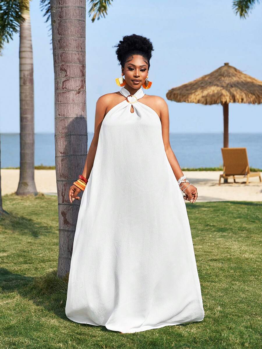 Embrace sunny days in this playful plus-size white dress, featuring a breezy sleeveless design and a flirty high-low hem. The textured woven fabric adds a touch of charm, making it perfect for casual spring outings or summer vacations. Lightweight and easy to wear, it’s your go-to for effortless style and comfort under the sun.