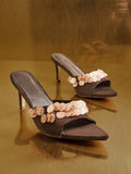 Front product view of brown embellished mule sandals with angular toes and slim heels