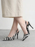 pair of black and white animal print pointed-toe slingback stiletto pumps