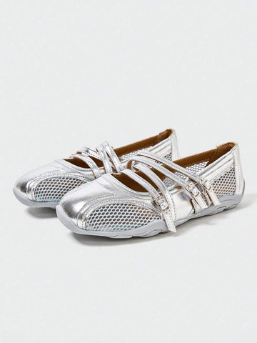 Front three-quarter view of silver three-strap Mary Jane flats with mesh panels and segmented sole