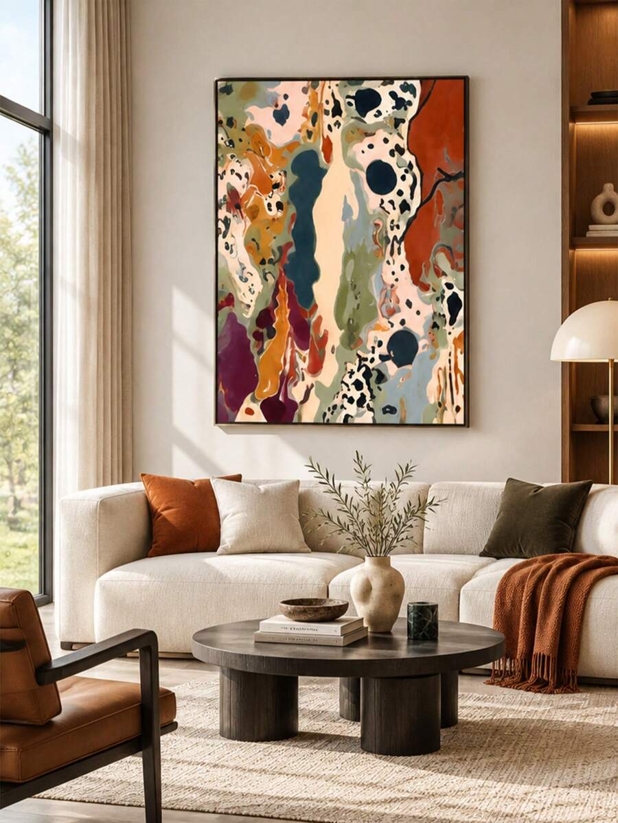 Living room view of framed abstract canvas art in rust, sage, cream and deep teal above a white sofa