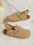 Beige suede look backstrap clogs with antique gold buckles
