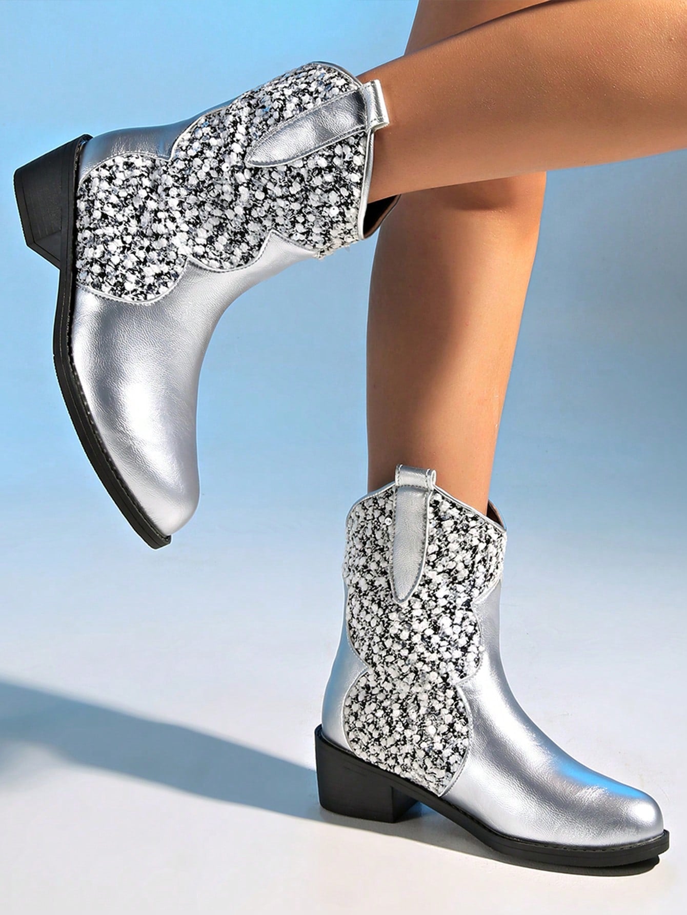 Step out in style with these Retro Glam Silver Metallic Knee-High Boots. Made for the fashion-forward woman, these bold boots feature a striking spike heel and a shiny metallic finish. Perfect for making a statement, these knee-high boots are sure to turn heads and elevate any outfit.