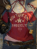 Front flat lay of burgundy layered graphic T-shirt with striped halter insert and New York print