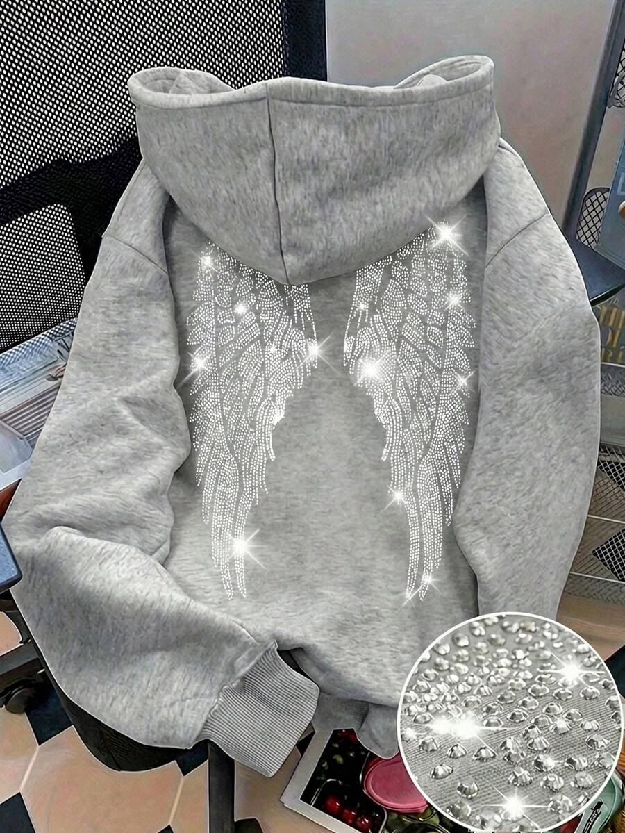 Make a bold statement with this Rhinestone Wing Graphic Sweatshirt for Women, designed to blend edgy style with everyday comfort. Featuring a sparkling rhinestone wing graphic on a classic black pullover, this sweatshirt adds a touch of glam to your casual wardrobe. Crafted from soft, comfortable fabric with a relaxed fit, it's perfect for staying cozy while looking effortlessly stylish.