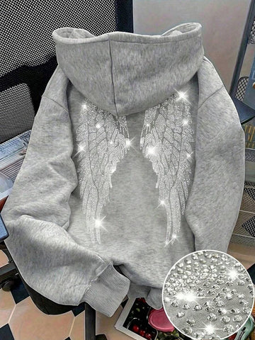 Make a bold statement with this Rhinestone Wing Graphic Sweatshirt for Women, designed to blend edgy style with everyday comfort. Featuring a sparkling rhinestone wing graphic on a classic black pullover, this sweatshirt adds a touch of glam to your casual wardrobe. Crafted from soft, comfortable fabric with a relaxed fit, it's perfect for staying cozy while looking effortlessly stylish.