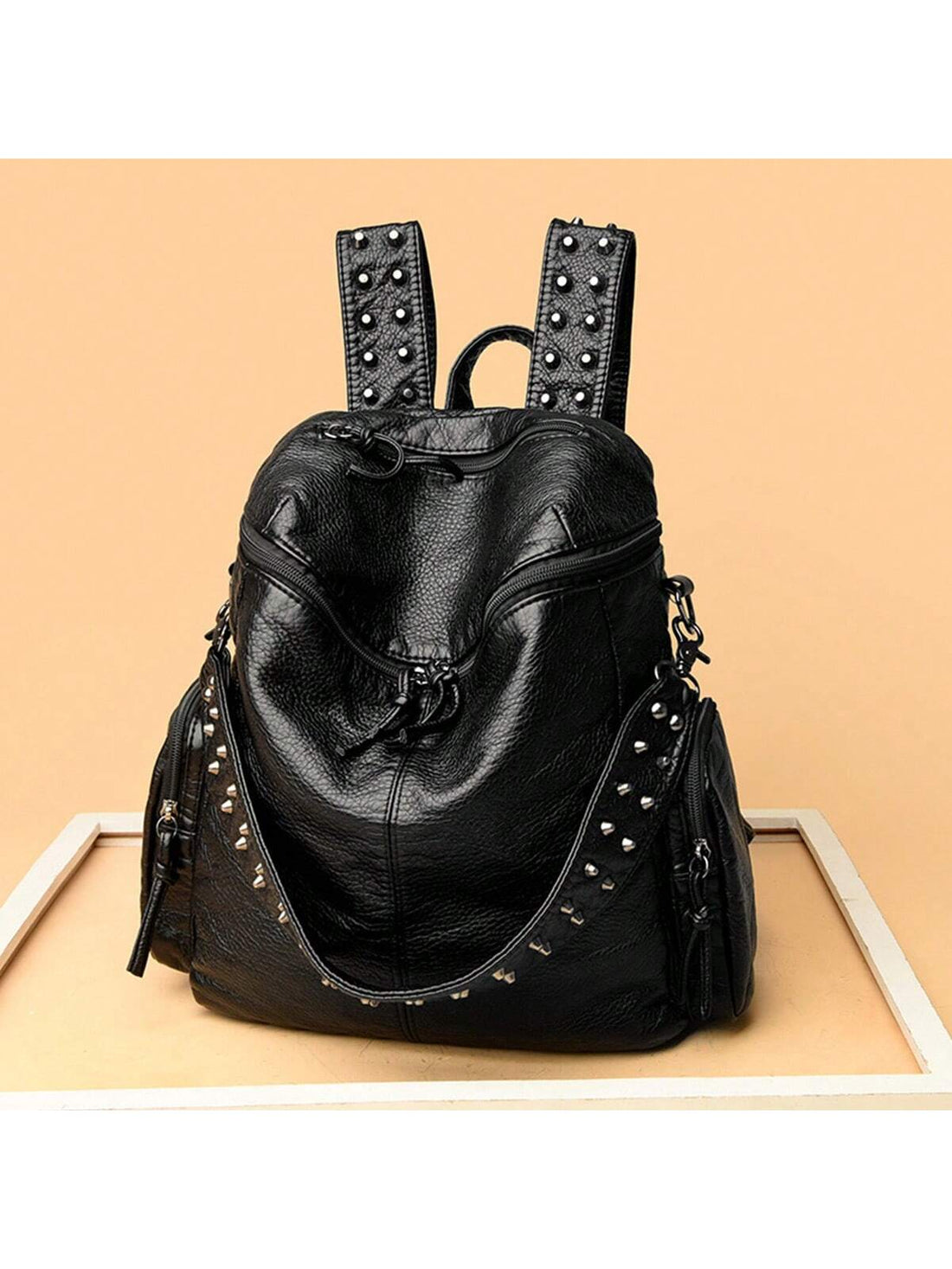Experience style and practicality with our Rivet Neutral Backpack. Made with durable materials, this backpack is perfect for your daily street outings and comfortably holds all your essentials. With its fashionable design and neutral color, it's the perfect accessory to elevate any outfit.