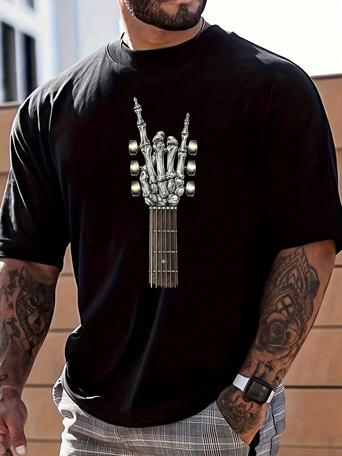 This men's t-shirt features a bold and unique design: a skeleton hand formed by the neck of an electric guitar. Show off your love for rock and roll with this comfortable and stylish shirt. Perfect for music enthusiasts and concert-goers alike.
