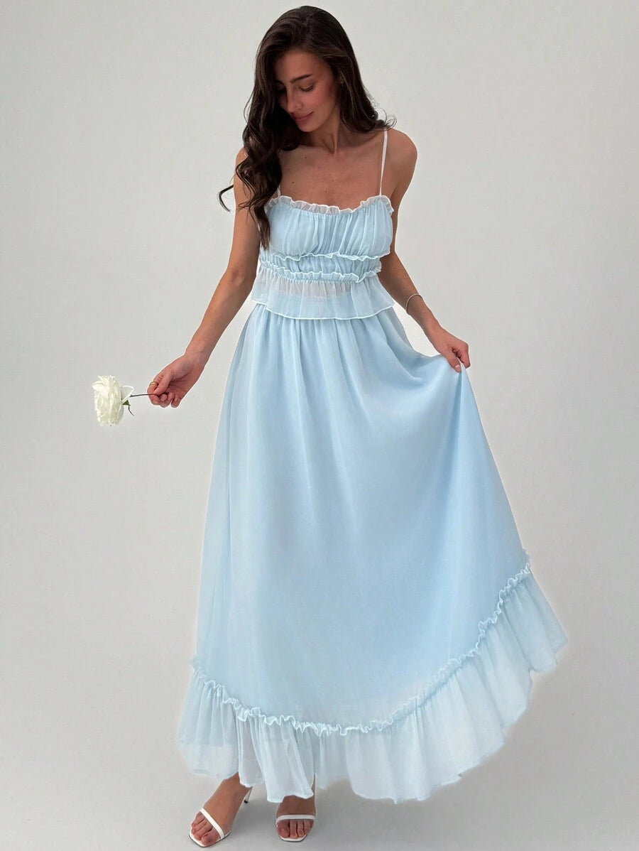 Turn heads on your next getaway with this flirty two-piece set designed for romance and adventure. The silky camisole features eye-catching contrast detailing that pairs perfectly with a playful ruffle skirt, creating an effortlessly chic look. Whether you're dressing up for a sunset dinner or exploring charming coastal towns, this set delivers vacation vibes with undeniable style. Mix, match, or wear together—versatility meets elegance in every wear.