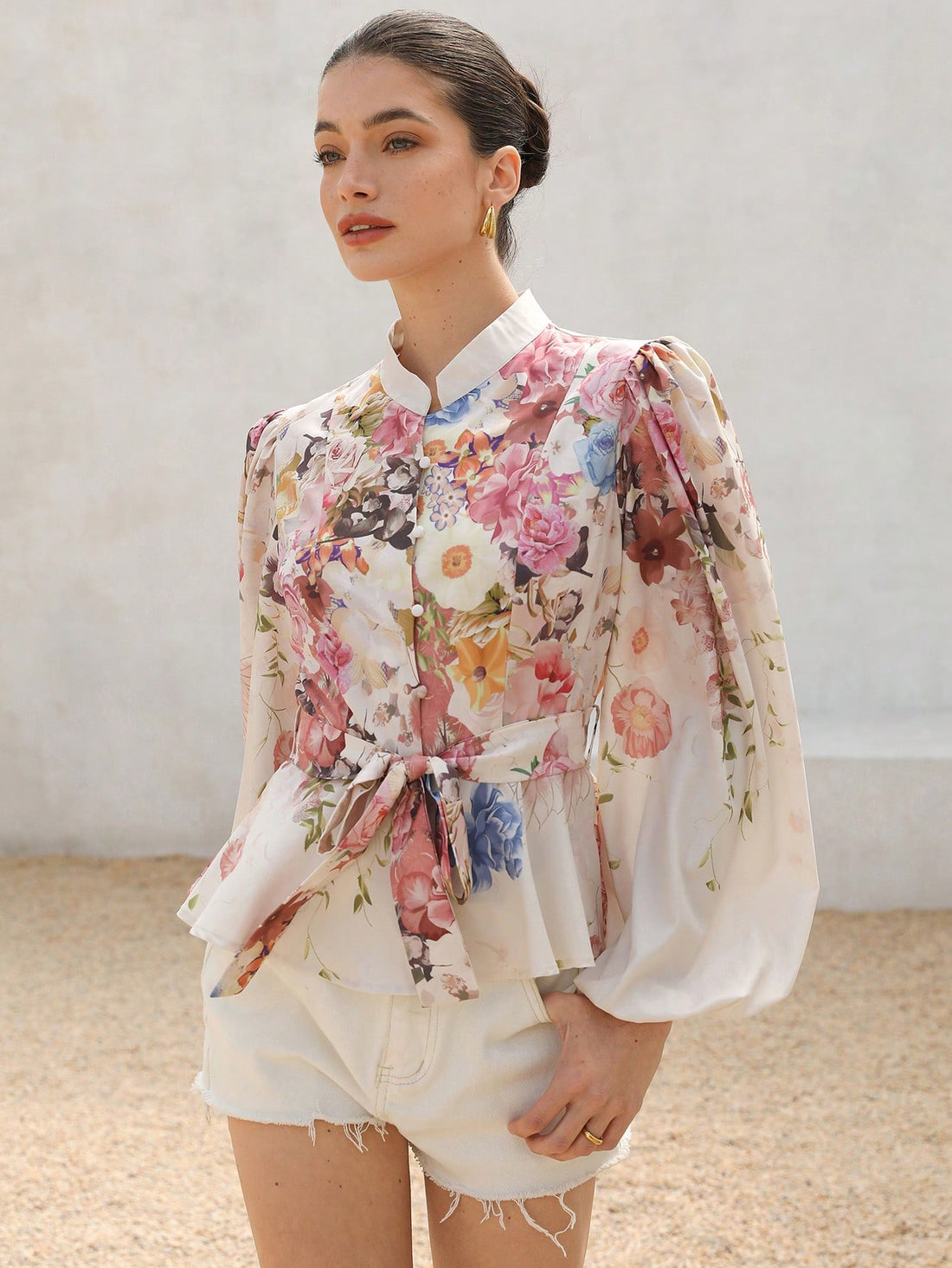 Embrace your elegant and romantic side with our Rosie Floral Stand-Up Collar Button-Down Shirt. Featuring a cinched waist for a flattering fit, this long sleeve shirt combines style and comfort. Perfect for adding a touch of charm to any outfit.