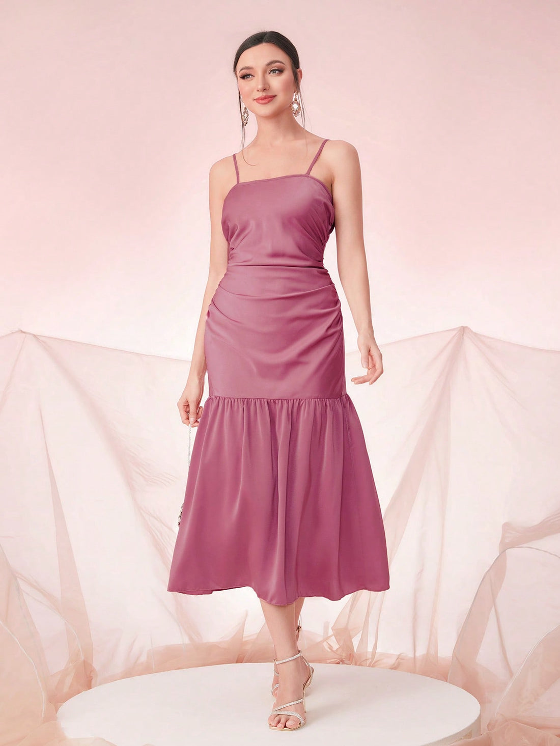 Get ready to turn heads in our Ruched Ruffle Hem Cami Dress! This elegant evening dress is perfect for special occasions and features a stunning ruched ruffle hem that adds a touch of glamour. Stay effortlessly stylish and comfortable at any event.