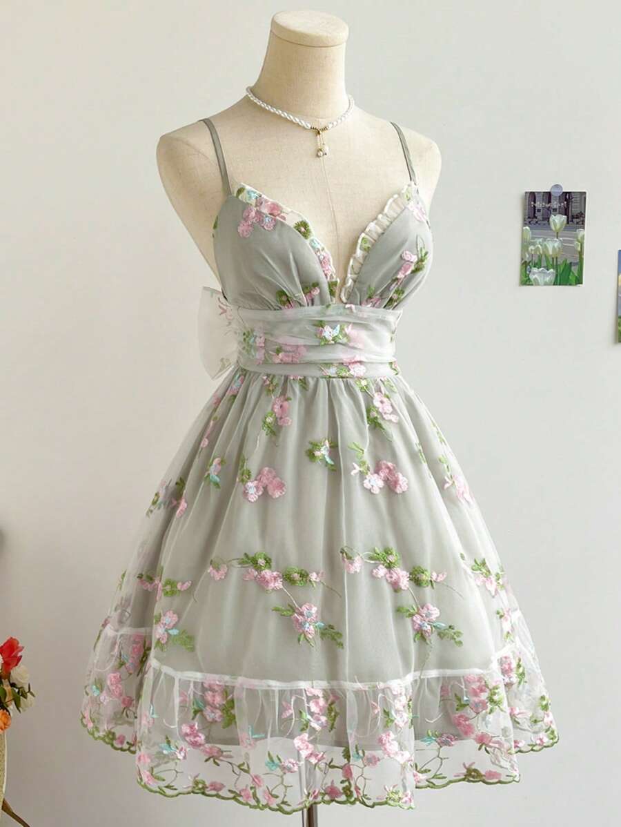 Sage gray floral embroidered organza mini dress with plunge neckline on mannequin