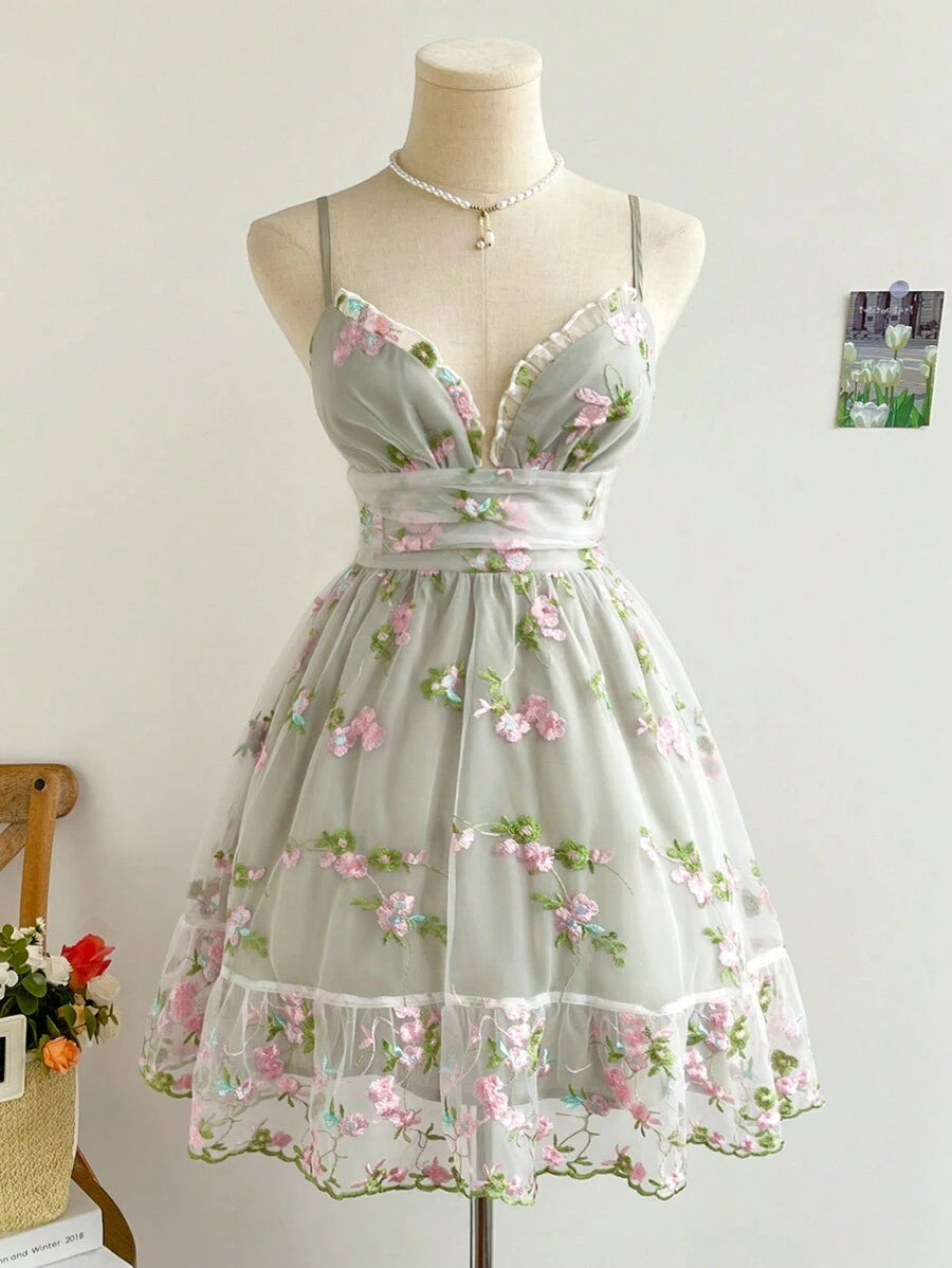 Sage gray floral embroidered organza mini dress with plunge neckline on mannequin