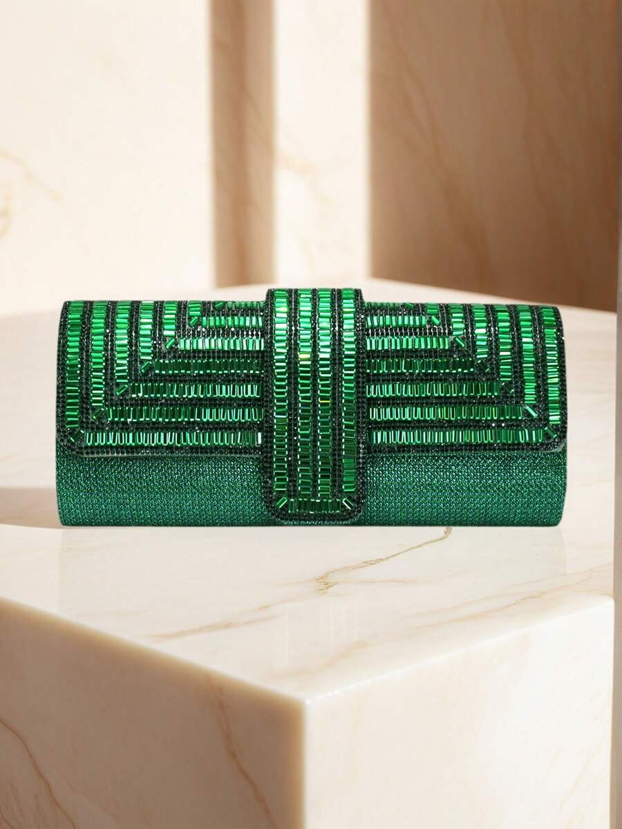 Emerald green rhinestone evening clutch on marble pedestal with geometric beaded flap