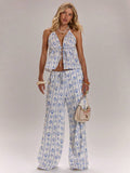 Dive into summer style with this eye-catching seashell print two-piece set. The tie-up halter top features a flattering neckline and adjustable fit, while the wide-leg pants offer effortless comfort and movement. Perfect for beach days, tropical getaways, or casual seaside strolls. The coordinated print creates a cohesive, fashion-forward look that transitions seamlessly from sand to dinner. Lightweight fabric keeps you cool in warm weather. 