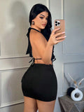 Back view of black open-back halter mini skirt set with tie straps