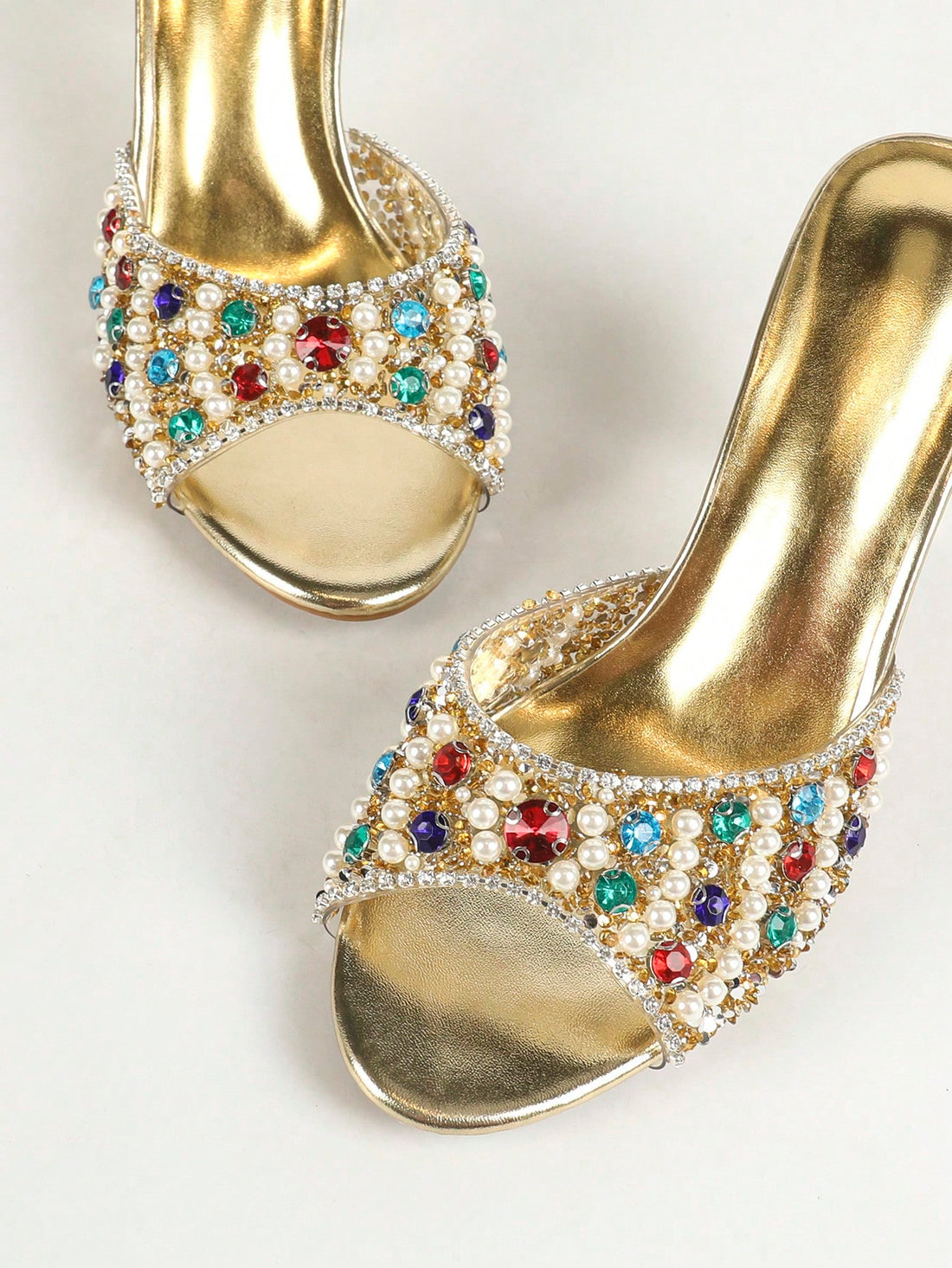 These Shimmering Elegance sandals are a stunning addition to any wardrobe. With multicolor rhinestone and pearl accents, they add a touch of elegance and sparkle to your outfit. The high heel provides both style and comfort, making them a perfect choice for any occasion.