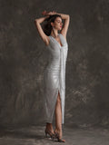 Get ready to shine in the Shimmering Elegance dress! This sleeveless glitter dress will add a touch of glamour to any occasion. With its eye-catching slit hem, you'll be sure to make a statement. Perfect for the fashion-forward and playful woman!