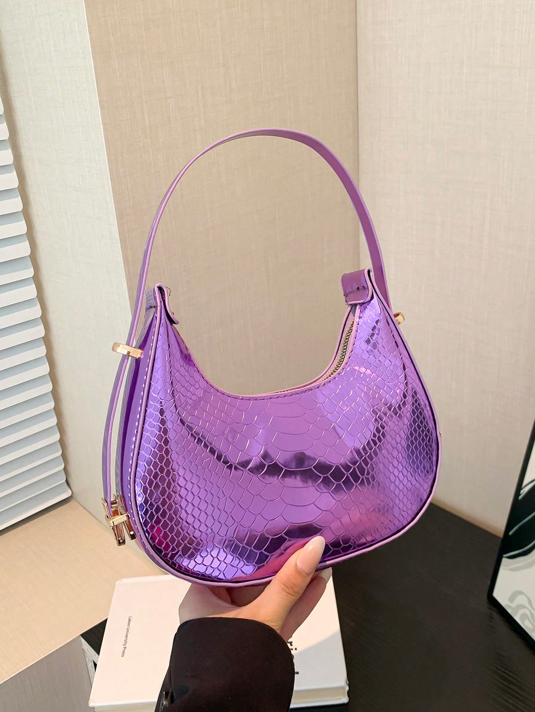 The Shimmering Serpent Shoulder Bag is the perfect addition to your collection. Its stylish and trendy design will elevate any outfit, while its shimmering material adds a touch of glamour. Crafted with high-quality materials, this bag is both durable and fashionable. Perfect for any occasion, make a statement with the Shimmering Serpent Shoulder Bag.