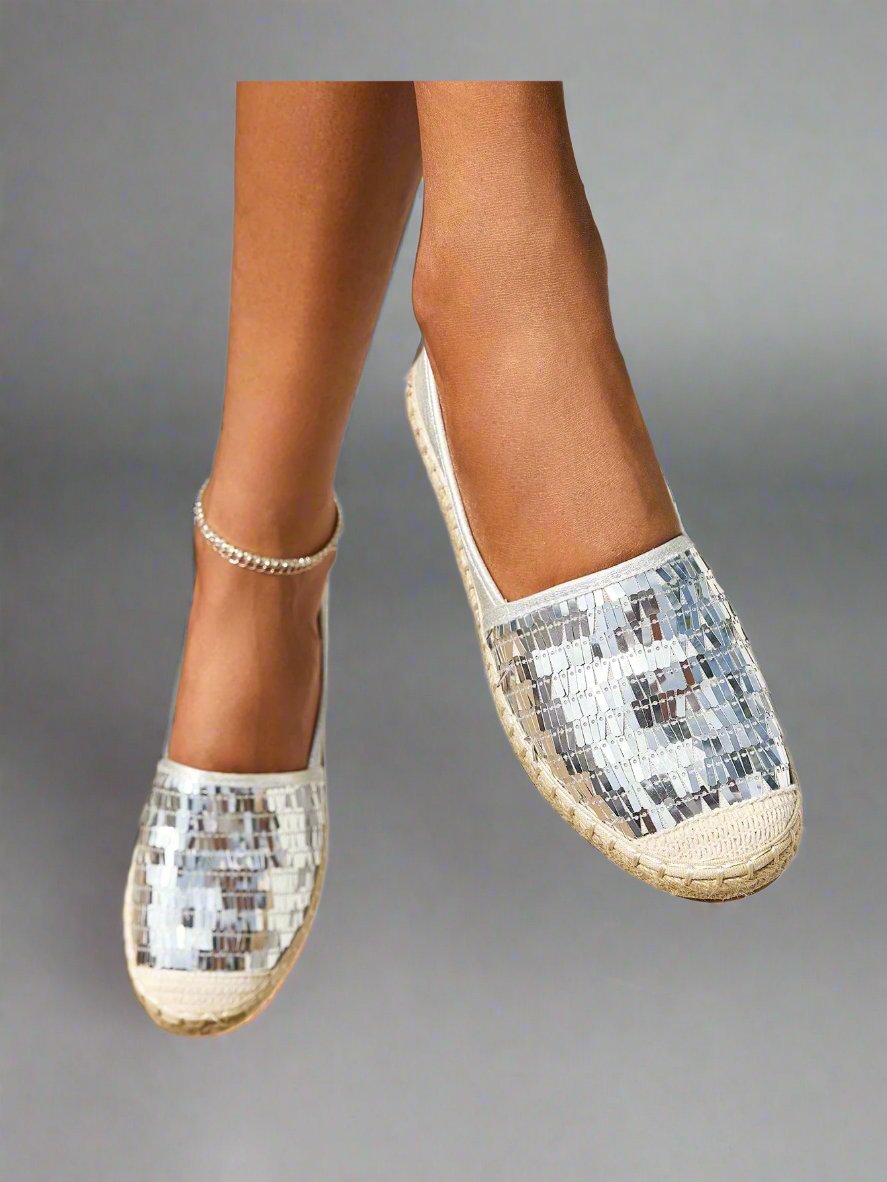 Introducing Shimmering Steps: Metallic Detail Espadrille Flats for Summer Vacation. These stylish flats feature a metallic design that adds a touch of glamour to any outfit. Perfect for your summer vacation, these flats will keep you comfortable and stylish. Step into your vacation in style with Shimmering Steps.