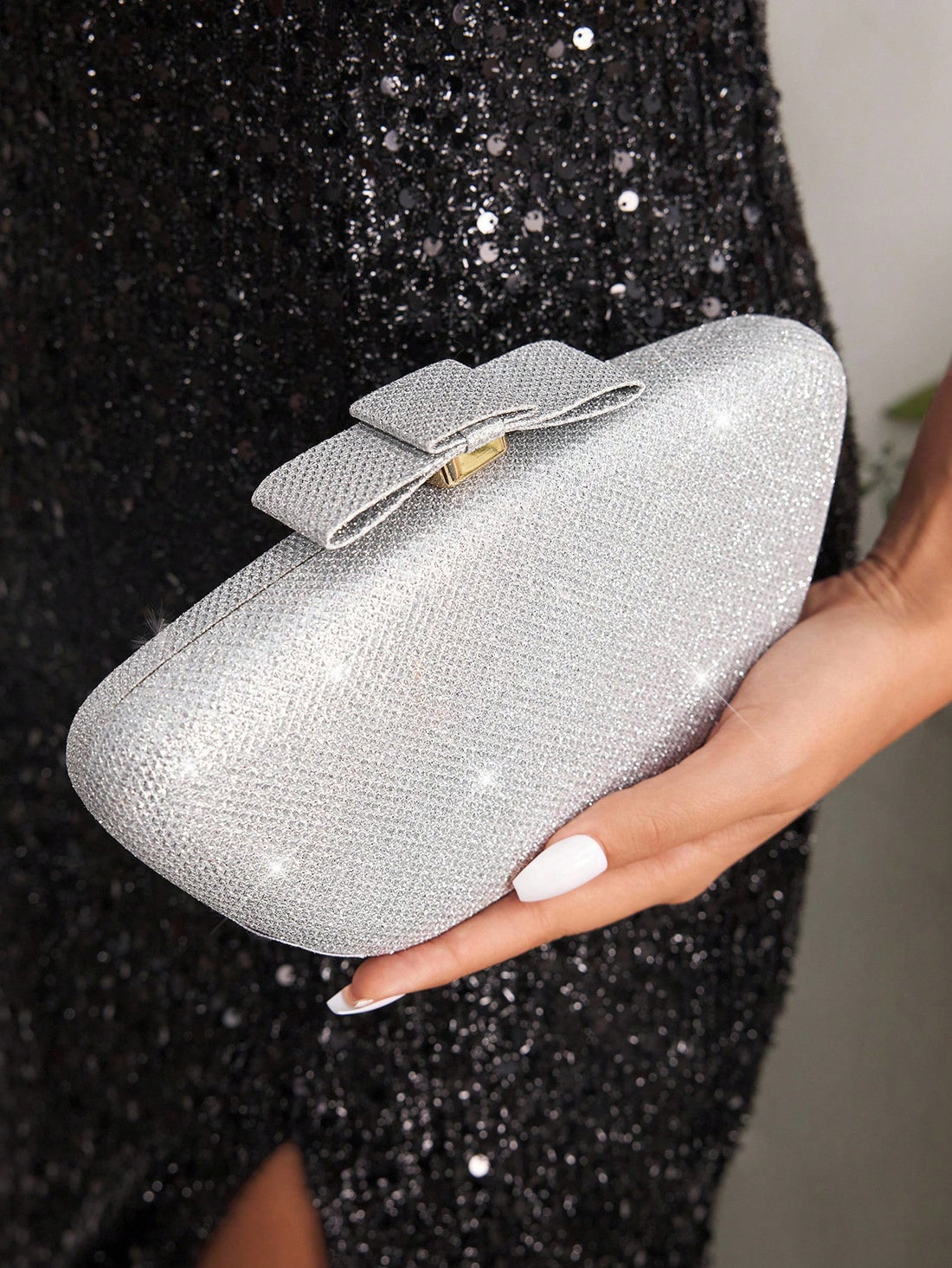 Make a statement with this dazzling clutch purse that's ready to steal the spotlight at any occasion. Crafted with a lustrous finish that catches the light beautifully, this glamorous handbag brings instant sophistication to your ensemble. Whether you're heading to an evening event or a night out with friends, its sleek silhouette and eye-catching shine ensure you'll turn heads wherever you go. The perfect size for essentials, this clutch pairs effortlessly with dresses, gowns, or chic outfits. Embrace your