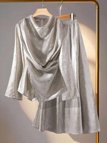 Elevate your cold-weather wardrobe with this show-stopping two-piece set! The asymmetric knotted top catches the light beautifully in shiny silver, while the draped hem midi skirt adds effortless elegance and movement. Perfect for autumn and winter occasions, this dynamic duo works together to create a polished, fashion-forward look that turns heads. Mix, match, or wear as a set—either way, you're guaranteed to shine.