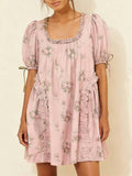 Front view of dusty blush floral smock mini dress with ruffled square neckline