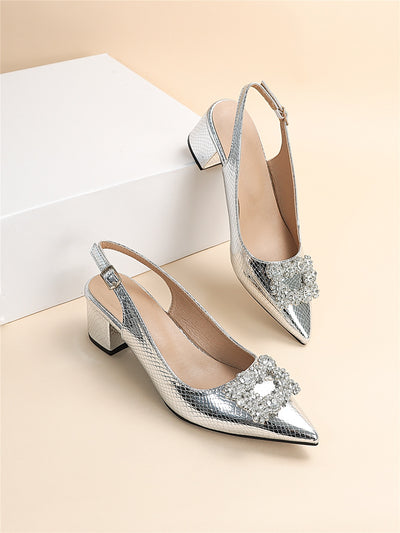 These Silver Serpentine Slingback pumps offer a touch of glamour with their metallic snakeskin design and rhinestone accents. You'll love their unique style and feel confident with their comfortable slingback fit. Elevate any outfit with these statement shoes.