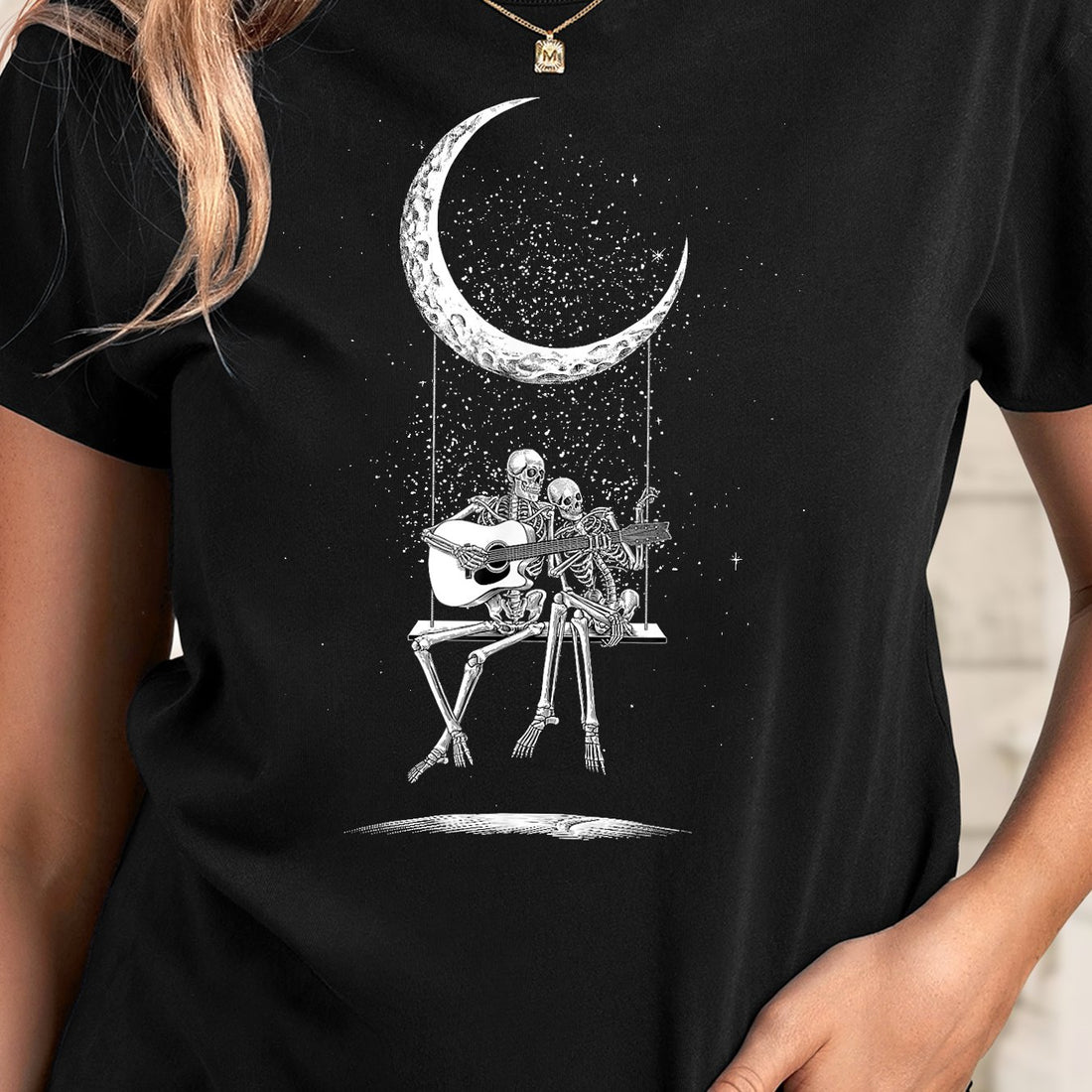 Stand out this Halloween with our Skull Rock Guitarist T-Shirt! Featuring a spooky moon and a guitarist skeleton, it's the perfect combination of rock and horror. Made for women, it's a casual top perfect for both concerts and parties. Don't let the night pass by without this hauntingly unique shirt.