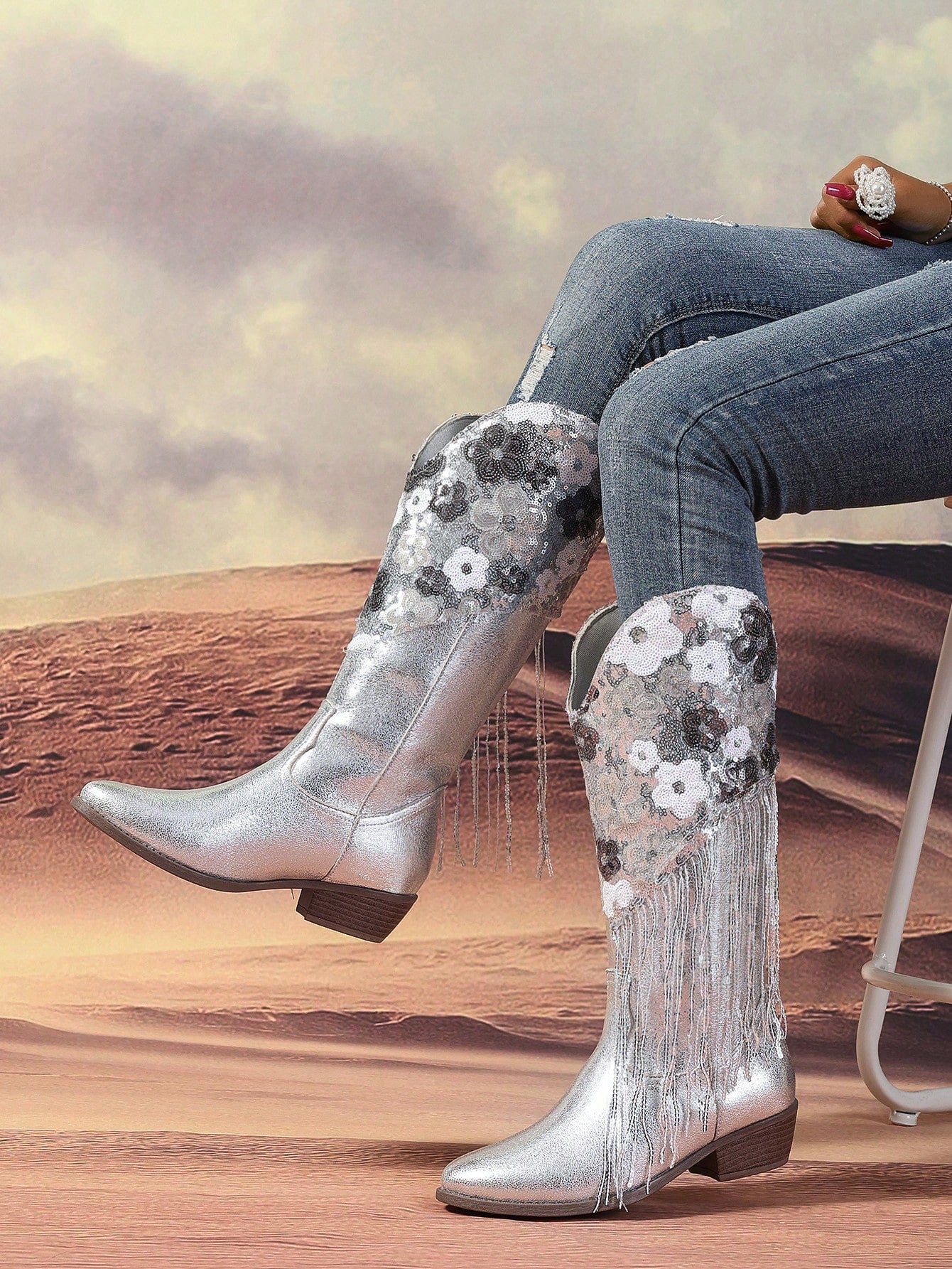 Elevate your fall/winter fashion with our sleek and chic silver floral sequin tassel trim knight boots. Embrace the season in style and comfort while making a statement with the intricate floral design and added tassel details. Perfect for keeping you on trend and warm all season long.