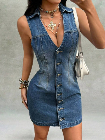 Front angled view of medium-wash button-front denim mini dress with pointed collar