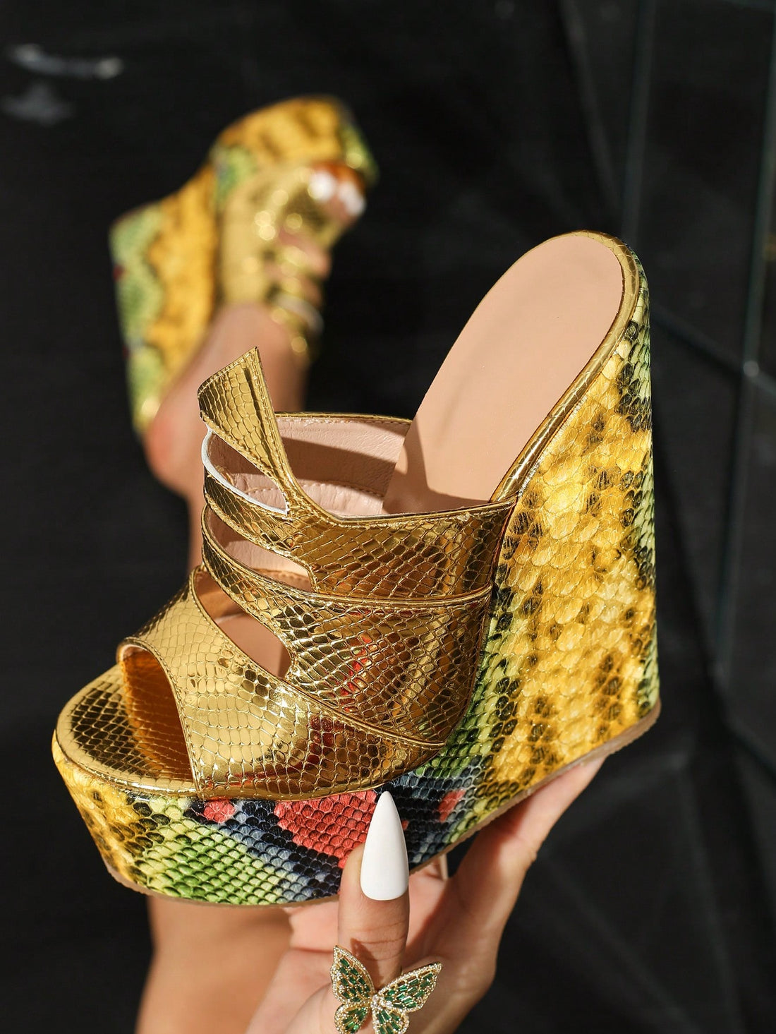 Step up your fashion game with our Snake Print Color Block Platform Sandal. Elevate your style with the super high heel, adding height and confidence to any look. The unique snake print and color block design make a statement, while the platform adds stability and comfort. Whether dressing up or down, these sandals will take your outfit to the next level.